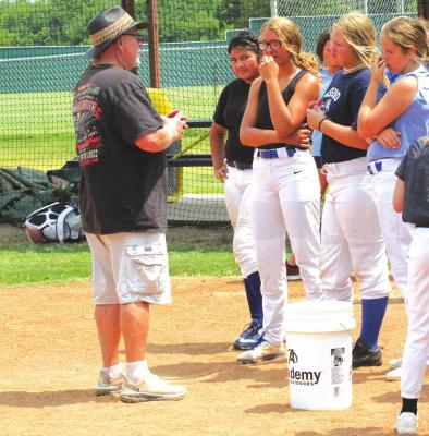 Holdenville head softball coach, Rick Scott, gives the junior high Wolverines a pep talk after a hot practice. The junior high will host Morris at 4 pm on August 9