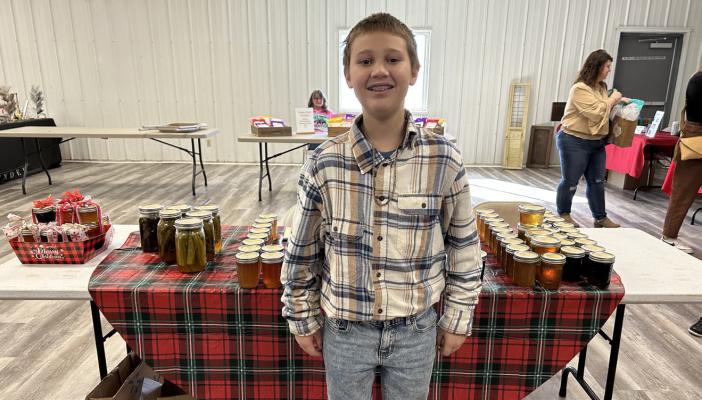ELIJAH HILL WAS QUITE THE SALESMAN at the Farm Bureau’s Farmtown Christmas market held at the Hughes County Expo Center. Eli was among many local vendors who came to sell their homemade products.