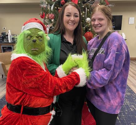 YOU CAN HAVE OUR CHRISTMAS, GRINCH, BUT HANDS OFF OUR MAIN STREET MIX! Gracie Smith saves the day with a loaded tea delivery for Sovereign Branch Manager, Breana Hester and the rest of the bank employees.