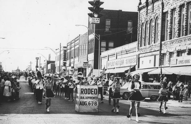 Holdenville was a three-stoplight town in the summer of 1964, and every building on Main Street was occupied by a business. It’s not hard to spot Amos Drug Store, the Dollar Store and Dalton Hardware. It was hot marching in the Holdenville Roundup Club’s annual rodeo parade. Twirlers that year were (left to right) Judy Pettit, Sherry Meek and Linda Kirby. Martha Foster was drum majorette. (Pettit, Kirby and Foster were members of the HHS Class of 1966.)