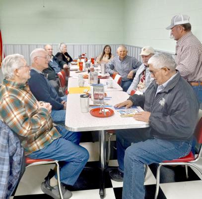 Pictured is Tail Twister Lion Leon Barrett performing his duties and fining Lions who are in attendance. Those in the photo l-r: Lion Les Radach, Lion Steve Enos, Steven Choate (Boy Scouts), Lion Theresa Barkhimer, Lion Lori Woods, Lion Jack Bush, Lion Larry Miller, Lion Leon Barrett (standing) and Lion Ernie Arocha. Not pictured is Lion Jerrie Lindsey.