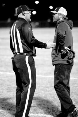 Holdenville head coach, David Barker, talks things over with one of the officials during a time-out. Holdenville defeated Luther last Friday 38-14.
