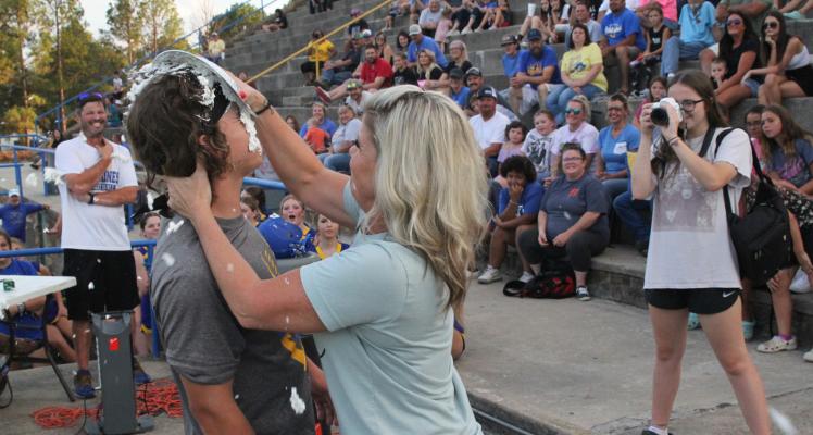 HUGHES COUNTY COURT CLERK AND SENIOR MOM ASHLEY SANFORD shows her love to son, senior football player Tatum Sanford.