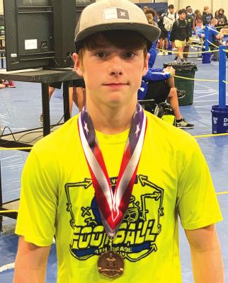 LEFT: Bringing home the hardware! Holdenville weightlifter, Tyler Orr, brought home the third-place medal from state weightlifting championship! Orr is an eighth grader at Holdenville Middle School.