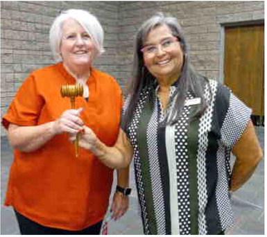 Lion Theresa Barkhimer receiving the President’s gavel from Lion Lori Woods.