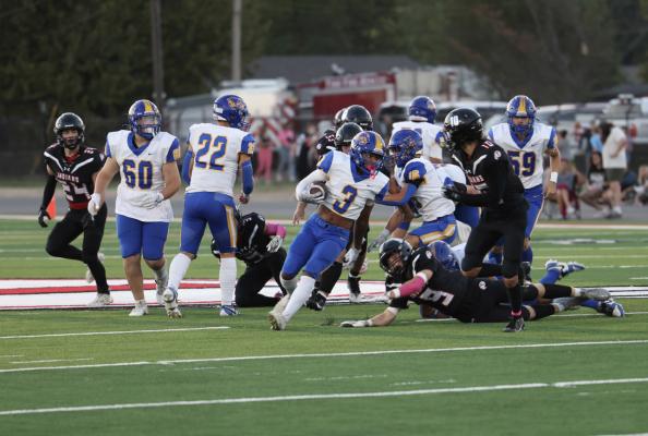 Holdenville running back # 3, Malachi Henderson, slips through the Tishomingo defense while # 22, Sawyer Jeffrey, # 60, Alyc Harjo, # 16, Kaden Rogers and # 59,Tank Redmond clear the way. Holdenville will host Beggs this Friday for another important district contest.
