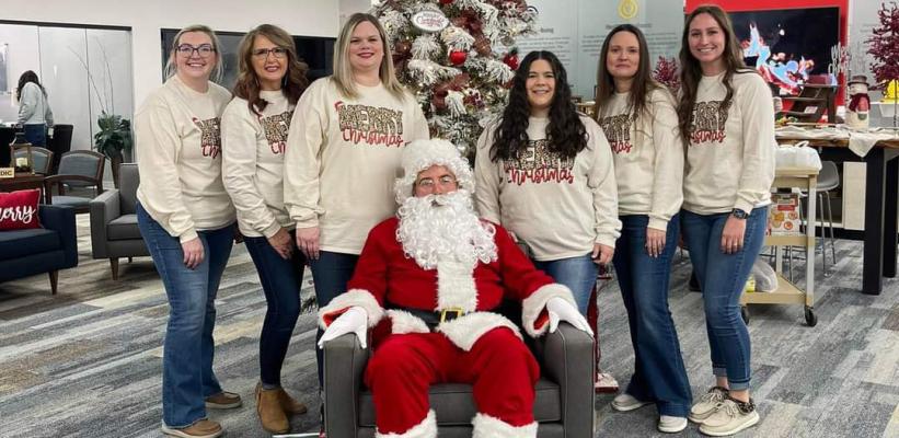 THE LADIES OF FIRST UNITED BANK CLAIM THEY HAVE BEEN GOOD ALL YEAR. SANTA SEEMED UNSURE. Always friendly faces at First United are (L-R): Ricki Purkins, Lisa Morgan, Naomi Moyer, Kayla Kiogima, Ashley Mitchon, and Kelcie Howell.
