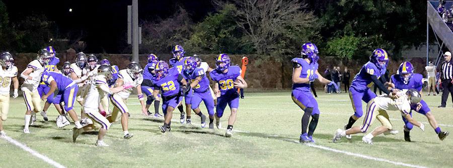 The Wolverine offense uses a series of fake hand-offs and misdirection. In this picture # 30 Bo Black has the ball while a Community Christian School defender attempts to tackle # 0, Abe Gomez. There are several Wolverine clearing the way for Bo Black. # 10 Camron Swayze, # 11, Tank Redmond, # 15 Tenetke Lowe,# 52, Aaron Torres,# 7 Brett Bruner, # 51, Jaxon Cox, # 56, Chris Palomera, and # 75, Roper Stafford.