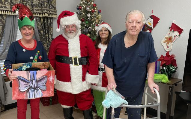 SANTA MADE A SPECIAL STOP AT HERITAGE VILLAGE NURSING HOME THIS WEEK. With the help of his elves from Davis Correctional Facility, Santa gave away a handmade toboggan and a gift bag to each resident. The hats were all made by the inmates of Davis Correctional Facility here in Holdenville.