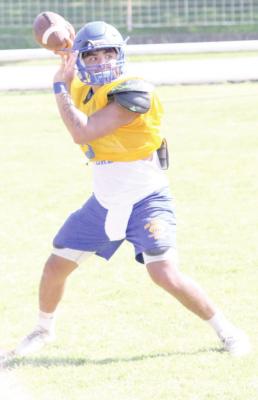 Holdenville quarterback, Devon Tiger, took his turn in one of the pre-season drills in a practice session last week. The Wolverines will open the season next week with the Wewoka Tigers.