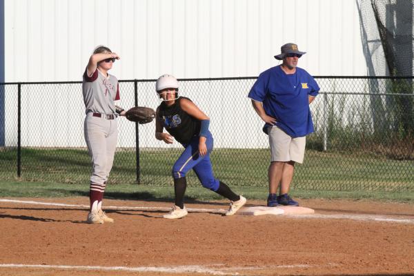 Mellissa Merriman is ready to run while Coach Casey Lavalley watchs from the first base.coach’s box.Holdenville will play at Allen on Monday and host Beggs at home on Tuesday.