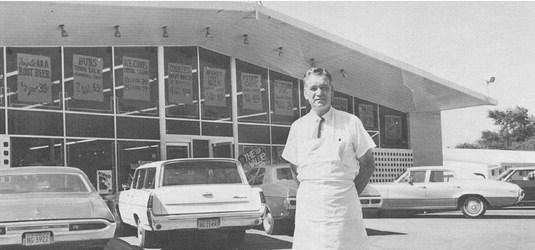 Mr. Ode Burton standing in front of his beautiful new store building.