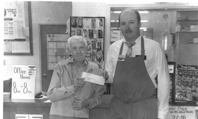 The late Dow Bean is pictured picking up his winning check from what used to be IGA Grocery in Holdenville. Dow and Inez Bean were well known, lifelong residents of Holdenville.