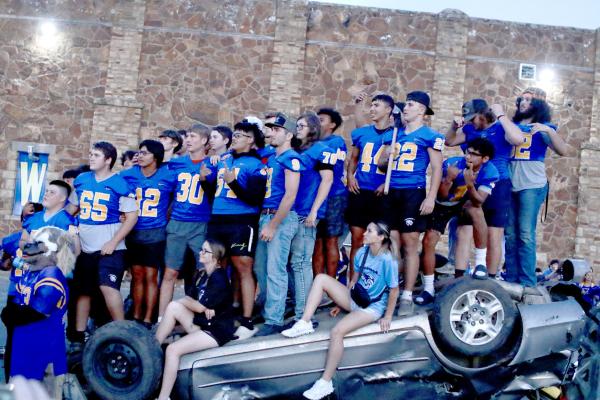 What do you do after you beat up a car with a sledge ....you stand on it! The Wolverines smashed this wreck at the Homecoming Pep Rally and then stood on the conquered auto!