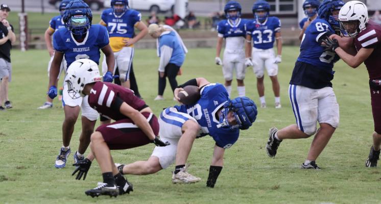 Holdenville’s Abe Gomez struggles to keep his balance while escaping a would be tackler. Holdenville will host a much improved Wewoka team on Friday.