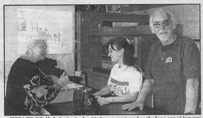 Looking Back around 1992—PIZZA TO GO. Hedy Justice is about to have a great meal as she buys one of Jumpin’ Jack’s delicoius pizzas from co-manager Jennifer Bleeker and owner Jack Holmes. Jumpin’ Jack’s Pizza will soon be open in a brand new location, but the pizza, spaghetti and sandwiches will stay as good as they are now.