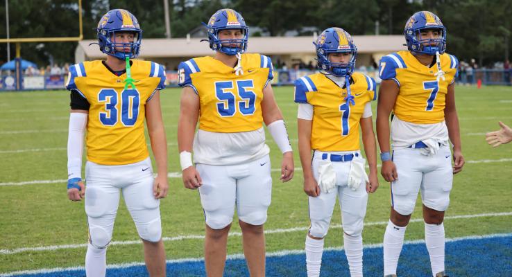 TEAM CAPTAINS... These 4 Wolverines were chosen as team captains for Holdenville’s home opener with Wewoka. # 30 Bo Black and his brother # 55 Brayden Black along with #1 Cash Lening and # 7 Brett Bruner participated in the winning coin toss.