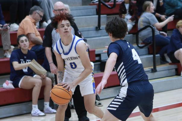 Kase Sipes looks beyond a Casady defender in the Wolverines first round of the Regional Tournament. Sipes scored 10 points in the contest.