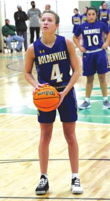 HOLDENVILLE WOLVERINE, LEISHA PHILLIPS has her eye on the basket prior to sinking another freethrow. Holdenville players, coaches and fans have their eyes and ears focused on the remaining part of the basketball season. The Wolverines are scheduled to play Allen on Tuesday and travel to Konawa for the Tiger Classic on Thursday.