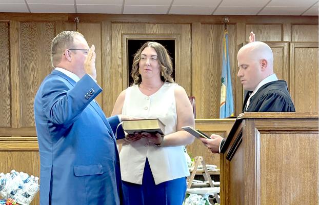 Ryan Pitts was recently sworn in as Special Judge of Seminole and Hughes County. He is pictured with his wife, Hillary and District Judge Brett Butner at the swearing in ceremony.