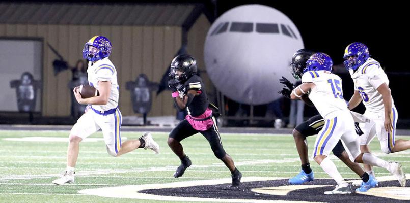 Wolverine blockers, # 15, Tenetke Lowe and # 56, Chris Palomera throw blocks that spring free running back # 30 Bo Black. Holdenville defeated Beggs 52-26 and will host Dibble for an important district game on Thursday.