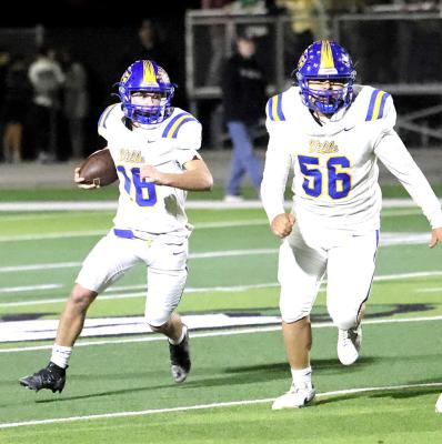 Holdenville running back, # 16 Memphis Thionnet made a good gain as # 56, Chris Palomera cleared the way.