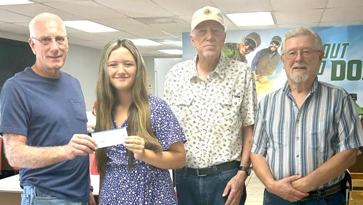 Pictured above l-r: Lion Steve Enos-Treasurer; Shelby Grissom Scholarship recipient; Lion Larry Miller and Lion Les Radach-Club members