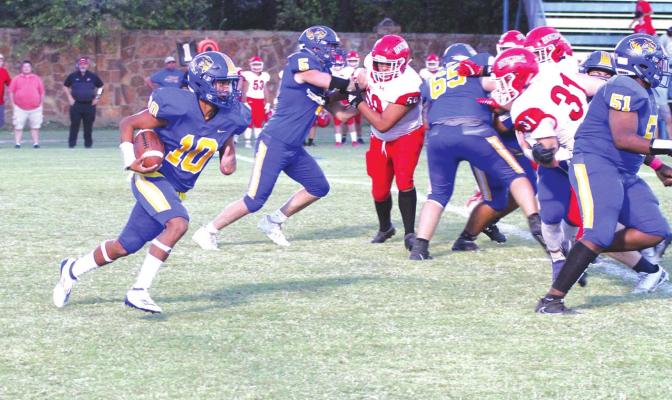 Holdenville quarterback # 10, Izaia King heads up field while # 5 , Cy Tiger, # 65 Clinton Lavalley, and # 51 Dierre Olden clear the way. Holdenville will travel to Bethel this Friday.
