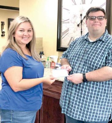 Kendal Logan of Security State Bank of Holdenville is shown presenting a check to David Clark, Resident Historian of the Hughes County Historical Society . The local museum depends entirely on donations. If you would like to donate please send your contribution to The Hughes County Historical Society, P.O. Box 303, Holdenville, OK 74848