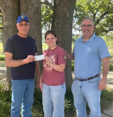 Lion Steve Enos and Lion Trey Irby are pictured presenting a Lions Club Scholarship to Reagan Irby.