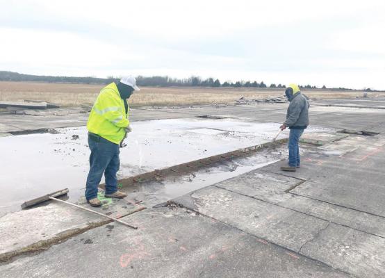 Contech, Inc. workers begin work on restoring the airport runway.