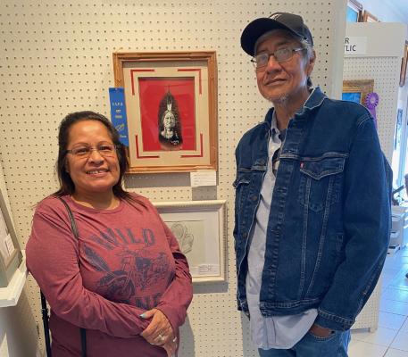 Reuben Culley pictured above with his wife in front of his first place entry “Sitting Bull”. Mr. Culley is one of the most talented artists in this area.