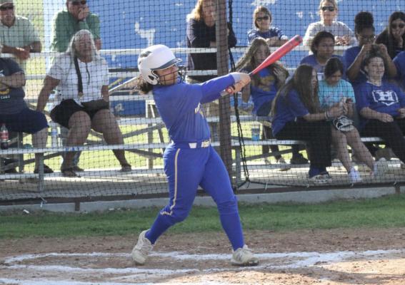Holdenville catcher, Bella Adam, swings away in Holdenville’s contest with Wewoka. Holdenville run ruled the Tigers by a score of 12-0.