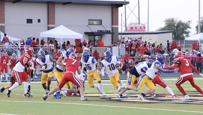 Holdenville running back # 10 Camron Swayze, follows the blocking of # 30.Bo Black,# 55 Braden Black, # 16 Memphis Thionnett, # 7 Brett Bruner and a host of other blockers. The Wolverines defeated Rock Creek 55-6.