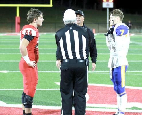 Holdenville’s #7 Gage Smith, and Purcell’s # 54, Carter Goldston, look on as the referee gives instruction on the overtime coin flip. Gage won the flip and the Wolverines chose to play defense first. The game went to double overtime before Purcell was able to score and win the game.