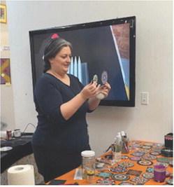 Instructor, Laura Calvery shows the class some of the basic Mandala samples that can be completed with a little practice.