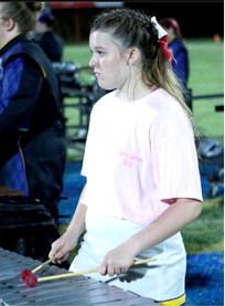 Tristin Goodman shows a look of concentration as she plays the xylophone at half-time of the Wolverines’ win over North Rock Creek.