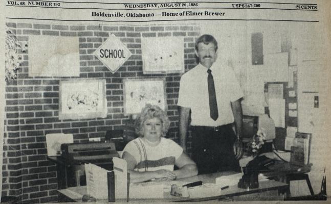 NEW THOMAS PRINCIPAL…LARRY MILLER is very excited about his new position in the Holdenville Public School System. After over ten years of coaching and teaching at the high school level, Larry was named as the principal of Thomas Elementary. He assumed the job to replace long-time principal Carl Morse. Miller said he has a good staff of teacher and other support personnel, and looks forward to his job. Above, Miller talks to Thomas secretary Kay Pitcock. (Staff photo by Herman Brown)