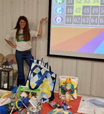 Lainee Yates AKA Vanna White shows the next number up at the 4-H Bingo night hosted by the Holdenville 4-H Club.