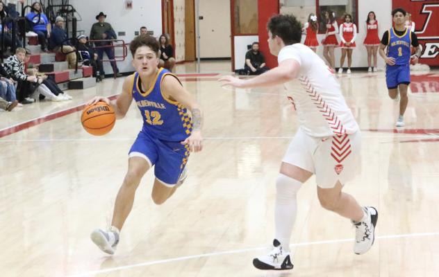 Wolverine guard, Wyatt Seeley, races by a Prague defender to score 2 0f his 11 points in Holdenville’s 56-55 win over the Red Devils. Holdenville will host Wewoka Tuesday night for a traditional Highway 270 match-up.