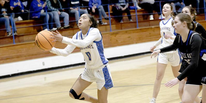 Holdenville’s Kmari Earley breaks away the Little Axe defenders on her way to score a basket in the Wolverines’ district championship 67 -19 win. The girls will travel to Jones on Thursday to begin regional tournament play.