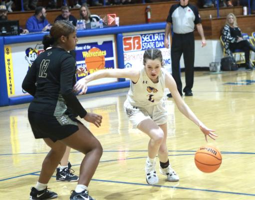 Holdenville guard, Madi McFarland drives past an Okemah defender. The Wolverines will play in the 66 Conference Tournament this week.