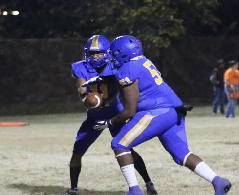 Holdenville quarterback, Izaia King, hands the ball off to # 51, Dierre Olden. Olden scored on the play.