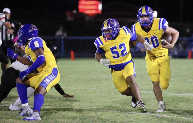 Holdenville running back # 30, Bo Black springs free behind the blocking of # 6, Joe Remis and # 52 Aaron Torres. The Wolverines are 5-0 and will travel to Beggs on Friday for an important district contest.