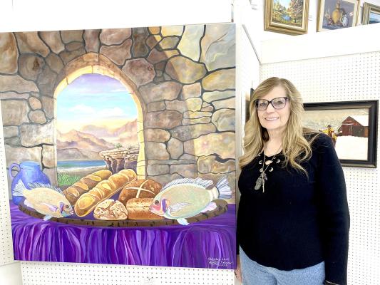 Kimberly Ramsey - Holdenville Kimberly is shown with her “Loaves and Fishes” painting she is donating to our local Loaves and Fishes ministry.