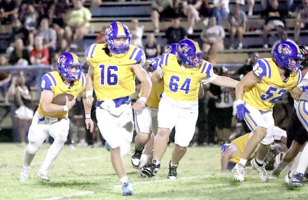 Wolverine Stampede....Holdenville quarterback, # 0 Abe Gomez, runs behind a wall of Wolverine blockers. # 16 Memphis Thionnet, # 64 Trey Carter, # 52, Lane Childs and # 11 Tank Redman are leading the way.