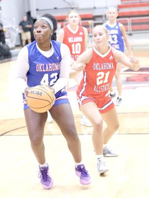 Holdenville Wolverine All-State forward, Myah Olden, takes aim at the basket while Weatherford’s Marley Teasley moves in to defend.