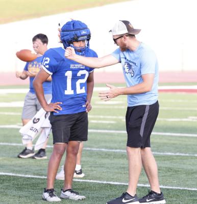 Holdenville assistant coach, Allan Hargis, gives instruction to a young defensive player during the Wolverines’ football camp at Atoka. The Wolverines are busy this summer preparing for the 2024 season.