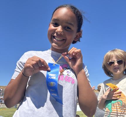 Essie Burdine won a Blue Ribbon at the Little Olympics!