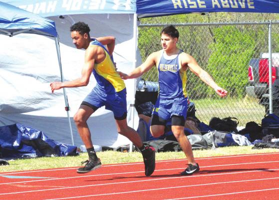 Holdenville sprinter, Devan Tiger, hands the baton to Garren Murray in the 4x200 race at Okemah. The relay team consisting of Devon Tiger, Izaia King, Garren Murray and Eddie Jennings finished 3rd in a field of 24 schools.
